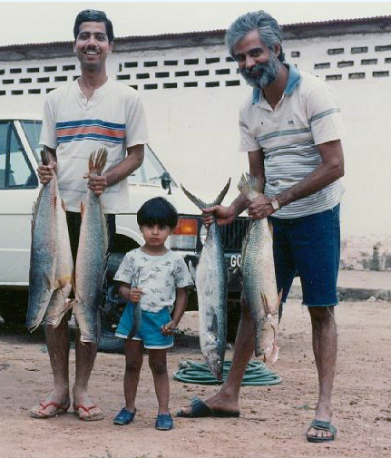 Michele holding a fish with his dad